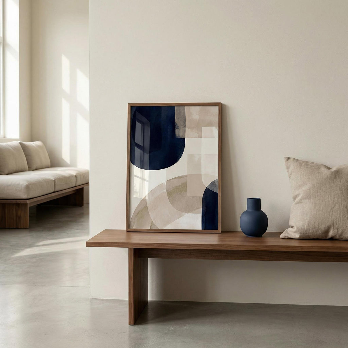 Modern living room with abstract art and a vase on a wooden table.