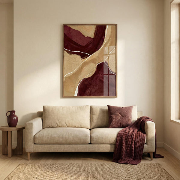 Beige sofa with a purple blanket and pillow in a room with abstract art on the wall.