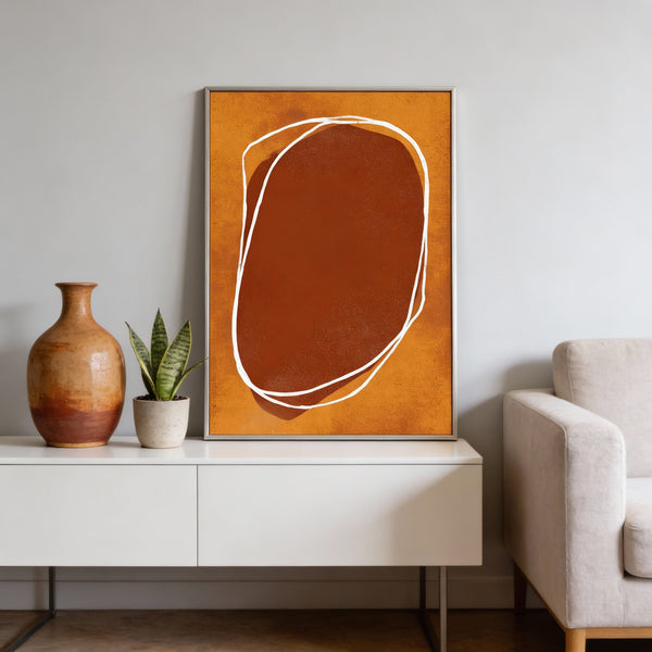 Abstract art piece on a wall above a white console table with decorative items.