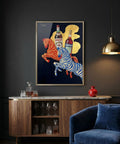 Framed artwork of two leaping zebras with Campari bottles on a dark wall above a wooden cabinet.