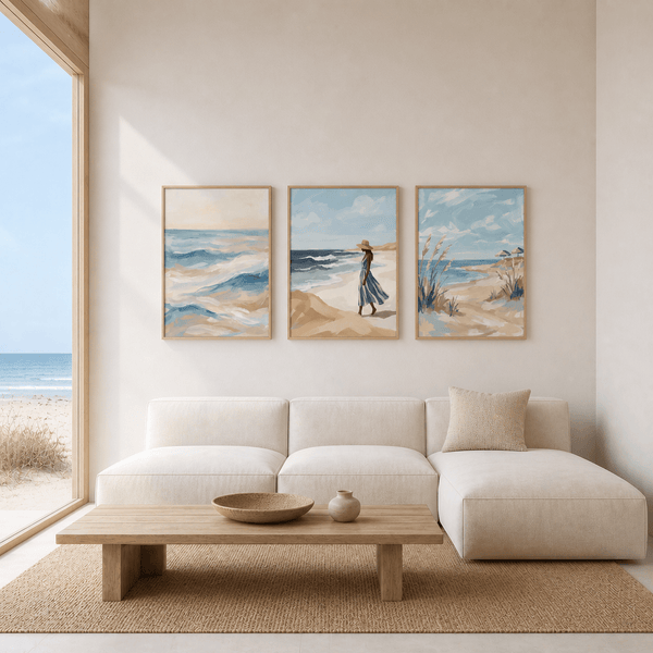 Modern living room with a white sofa, wooden coffee table, and beach-themed wall art.