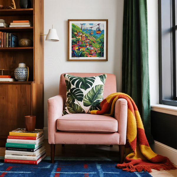 Pink armchair with a colorful blanket and leaf-patterned pillow in a cozy room.