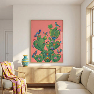 Colorful cactus artwork with birds on a pink background in a living room.