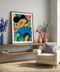 Colorful artwork of a woman holding a fan on a shelf in a living room.