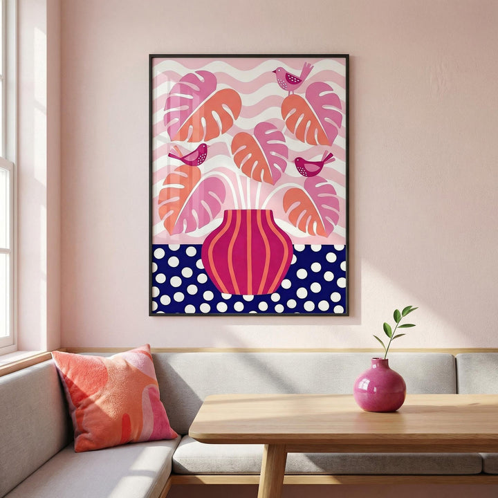 Tropical Plant wall art with pink and coral leaves in a black frame above a sofa with a pink cushion
