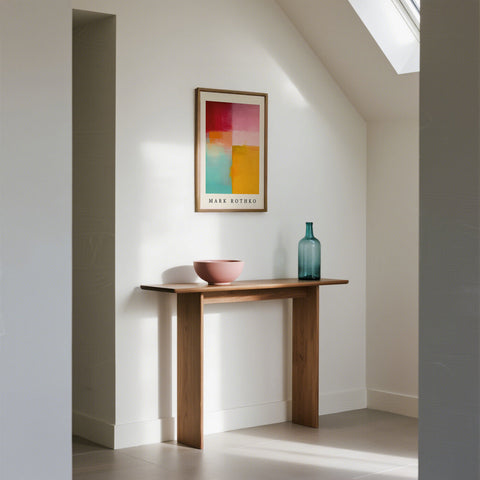 Modern interior with a wooden console table, color block art, and decorative bottle.