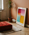 Room interior with a red cushion, potted plant, and Mark Rothko color block art on a wooden floor.