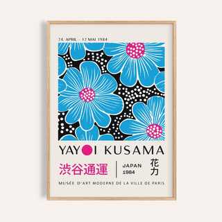 Framed close-up of large modern floral wall art with blue flowers and pink centres on black background