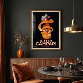 Framed Bitter Campari Milano poster on a dark wall above a dining table.