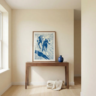 Framed artwork of a greyhound on a wooden console table against a beige wall.
