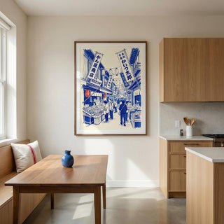 Framed artwork of a street scene in a modern kitchen with wooden furniture.