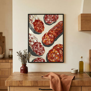 Framed artwork of salami on a wall above a wooden counter with kitchen items.