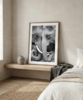 Framed black and white elephant photograph in a bedroom setting