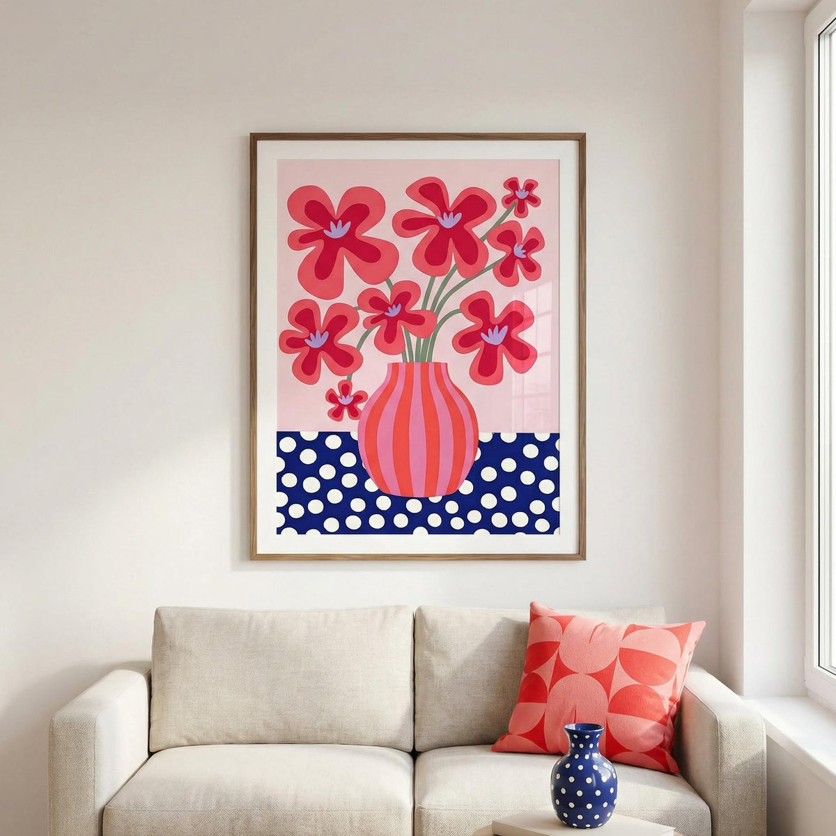 Framed floral artwork on a wall above a sofa with matching decor.