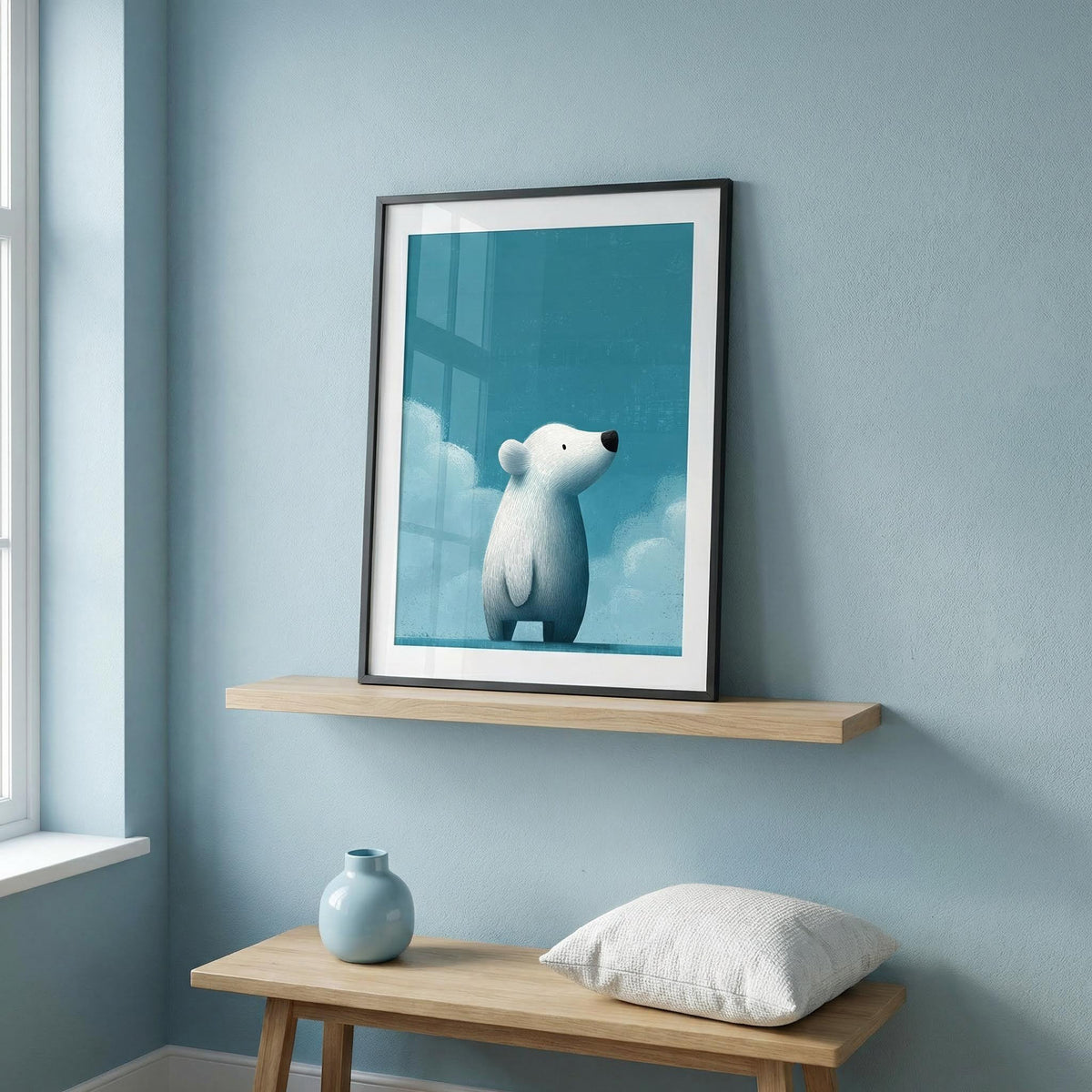 Framed picture of a polar bear on a shelf against a light blue wall.