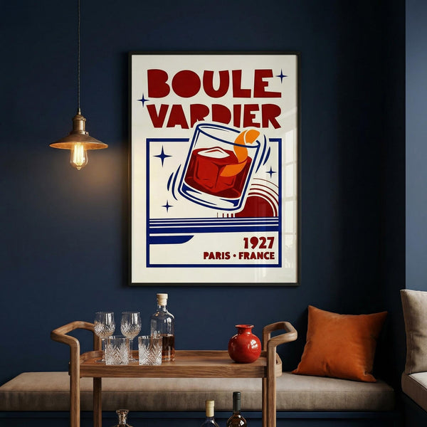 Framed poster of Boule Vardier on a dark wall above a wooden table with glasses and a bottle.