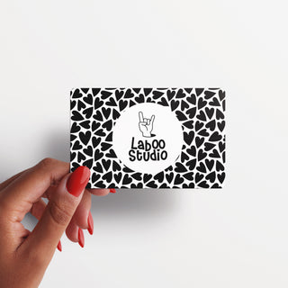 Art Gift Card held in hand showing hand making rock sign with black hearts background