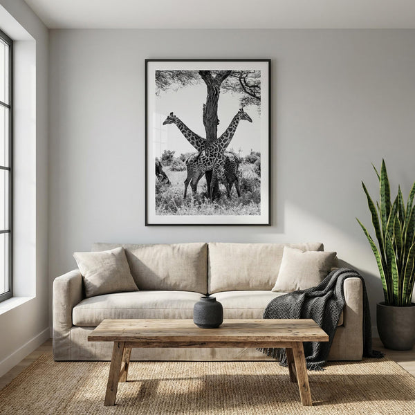 Living room with a beige sofa, wooden coffee table, and framed black and white giraffe print on the wall.