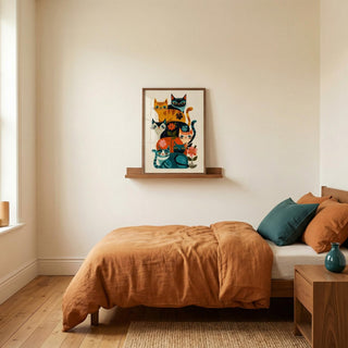 Bedroom with a bed, nightstand, and wall art of cats.