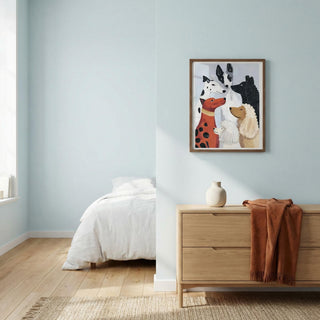 Bedroom with a dresser, bed, and wall art featuring dogs.