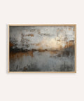 Abstract painting with earthy tones in a wooden frame on a white wall