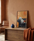 Living room with a painting of a dog on an armchair, a vase, and a blanket.