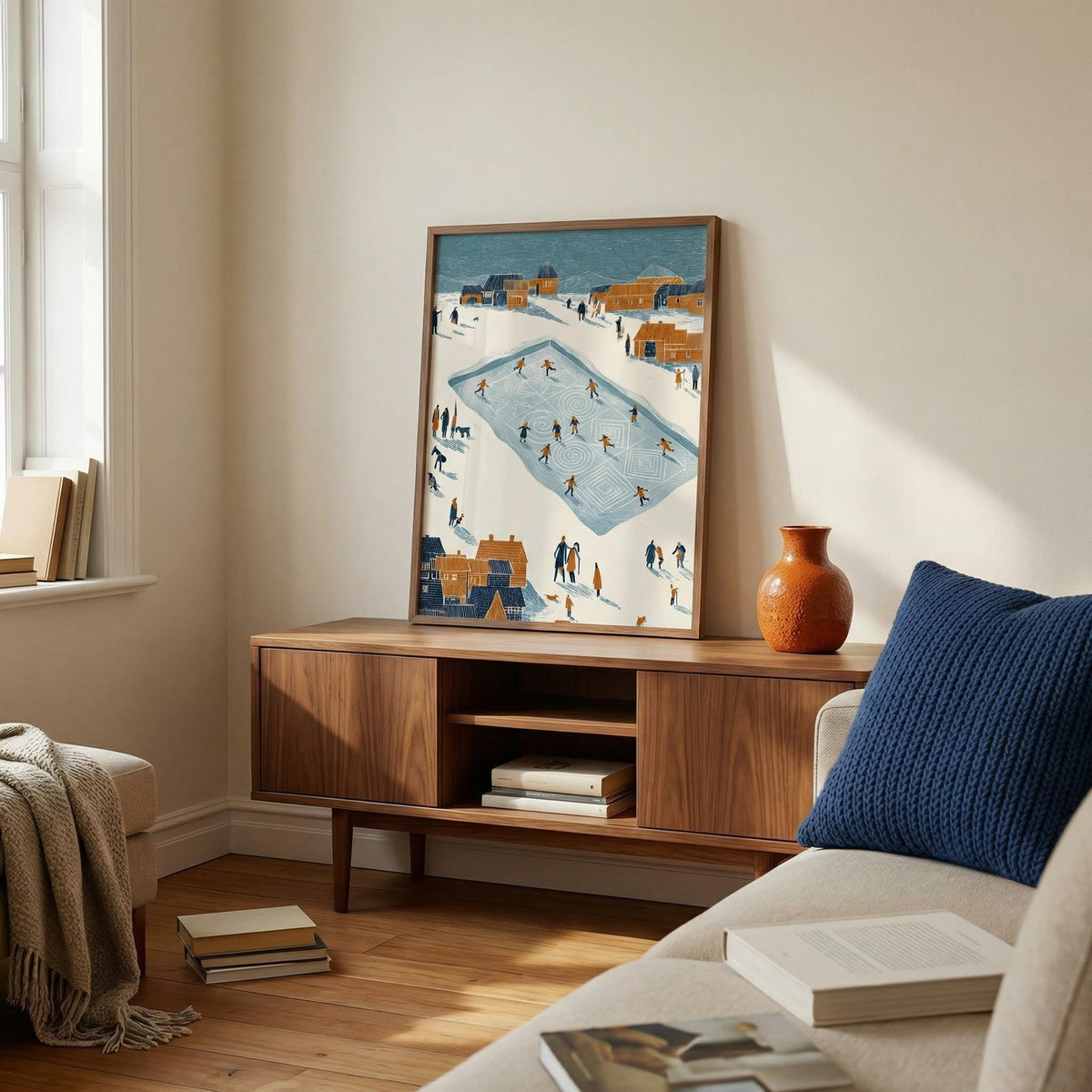 Living room with wooden cabinet, framed artwork, and decorative items.