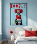 Framed artwork of a dog wearing a red sweater and hat on a blue wall above a bed.