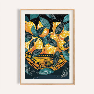 Framed print of lemon wall art showing yellow lemons in a patterned bowl with green leaves on a dark background