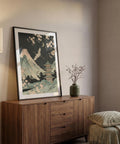 Wooden sideboard with a framed artwork and vase in a room setting
