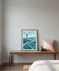 Framed artwork on a wooden bench with a pink pillow against a plain wall.