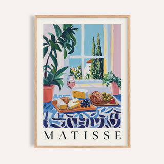 French prints artwork with bread, cheese, and rosé on a blue patterned table

