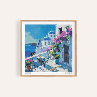 Framed Santorini wall art prints showing blue domes and white buildings with pink flowers in contemporary watercolour style
