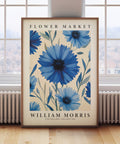 Vintage floral wall art featuring blue cornflowers and green leaves
