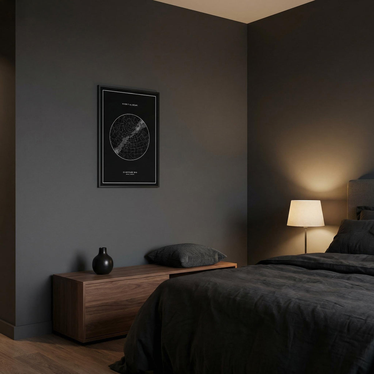 Modern bedroom with dark walls, a bed, nightstand, and framed map on the wall.