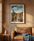 Living room with a brown leather sofa, framed desert painting, and a small table with a vase.