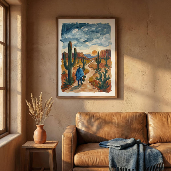 Living room with a brown leather sofa, framed desert painting, and a small table with a vase.