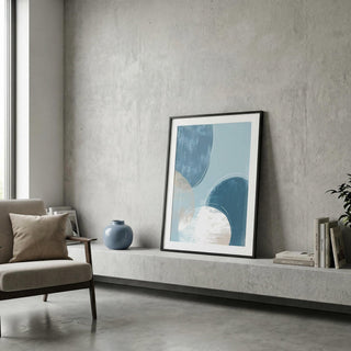 Framed abstract art piece on a concrete wall in a modern living room.