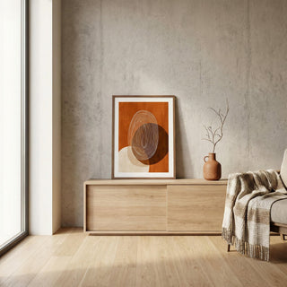 Modern interior with a wooden sideboard, abstract art, and a vase against a concrete wall.