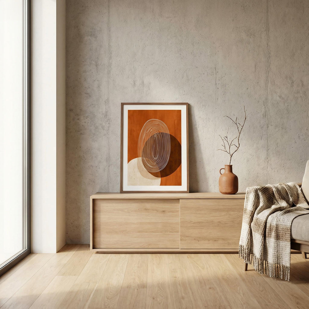 Modern interior with a wooden sideboard, abstract art, and a vase against a concrete wall.
