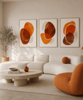 Modern living room with a white sofa, orange chair, and abstract art on the wall.