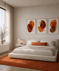 Modern bedroom with a bed, orange rug, and abstract wall art.