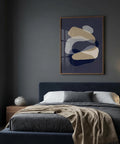 Modern bedroom with a bed, abstract art on the wall, and side table.