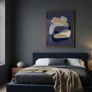 Modern bedroom with a bed, abstract art on the wall, and side table.