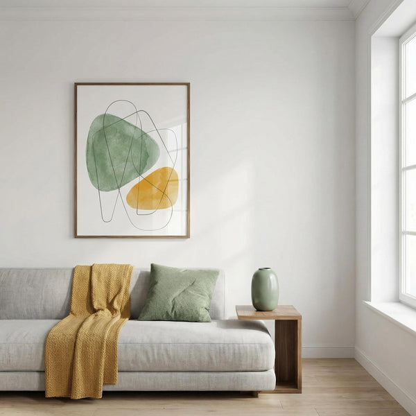 Modern living room with a gray sofa, yellow throw blanket, green pillow, and abstract art on the wall.
