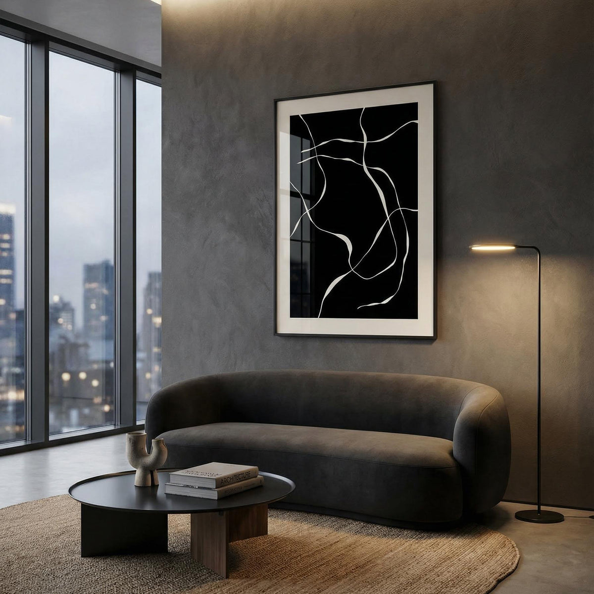 Modern living room with a gray sofa, round coffee table, and abstract art on the wall.