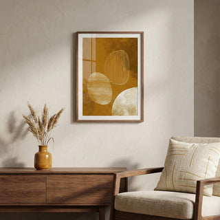 Framed abstract art on a wall above a wooden console table with a vase and chair.