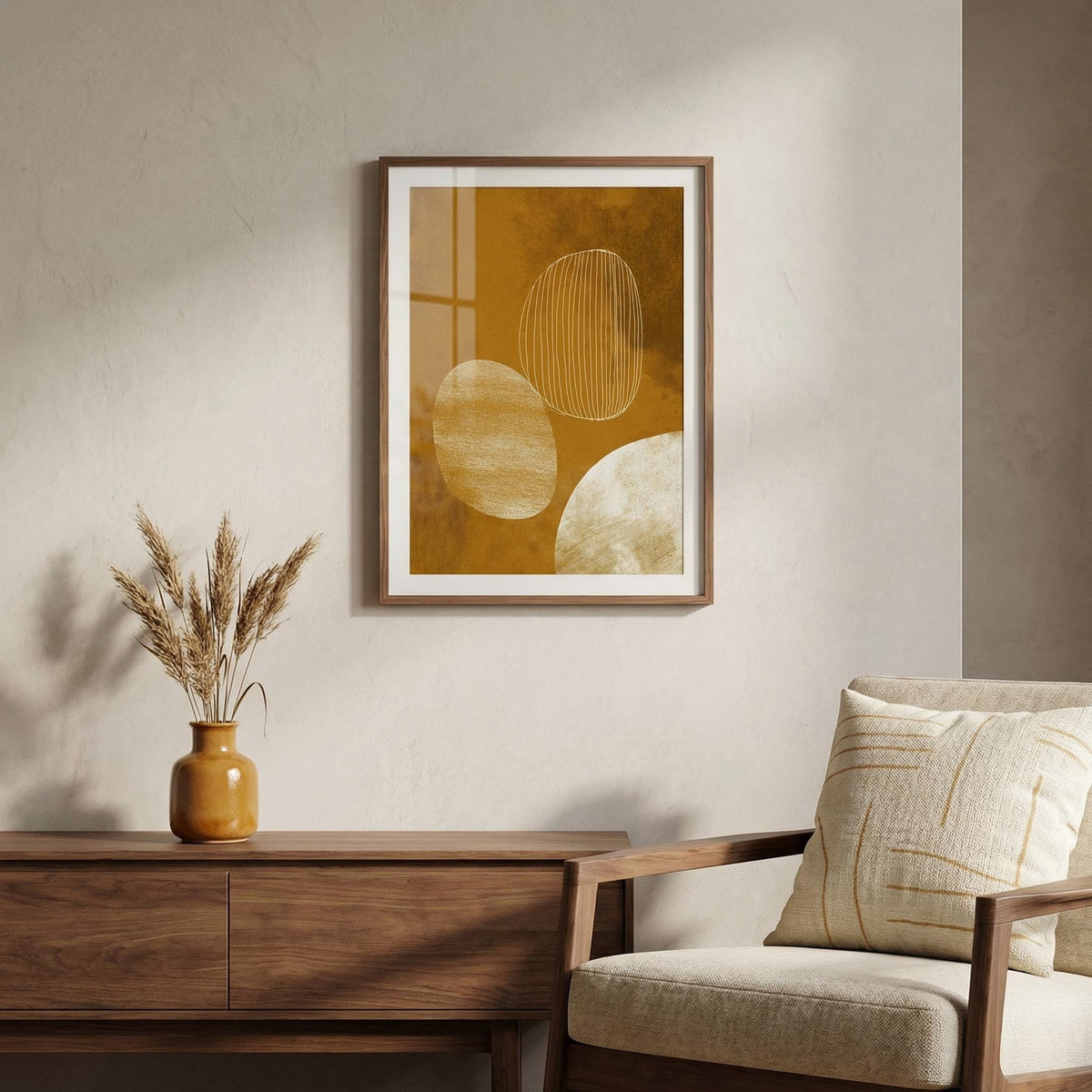 Framed abstract art on a wall above a wooden console table with a vase and chair.