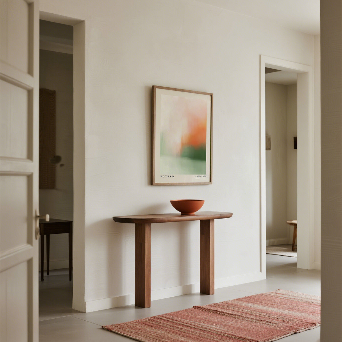 Wooden console table with a bowl and abstract painting in a minimalistic room.
