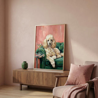 Framed painting of a poodle on a wall above a wooden cabinet with a vase and a chair.